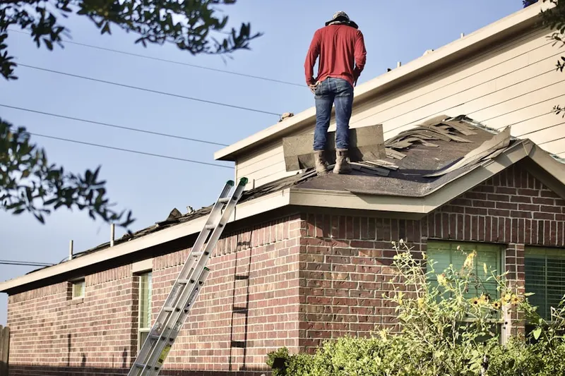 Professional roofer working on a residential roof in Beach Bluff